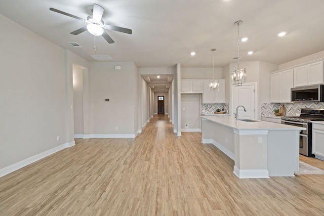 1116 Highwater Dr, Georgetown, TX 78628 - kitchen with stainless steel appliances, backsplash, light wood-type flooring, white cabinetry, and light countertops
