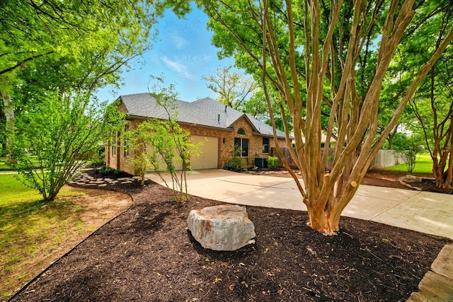 3000 Warwick Way, Austin, TX 78748 - view of front facade featuring brick siding, concrete driveway, a garage, and roof with shingles