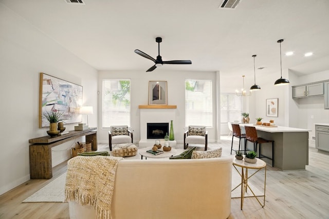 3000 Warwick Way, Austin, TX 78748 - living room with light wood finished floors, ceiling fan, and a fireplace