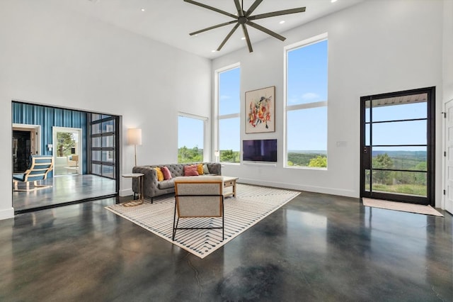 2300 Stagecoach Ranch Loop Unit B, Dripping Springs, TX 78620 - living room featuring a high ceiling, ceiling fan, finished concrete flooring, baseboards, and recessed lighting