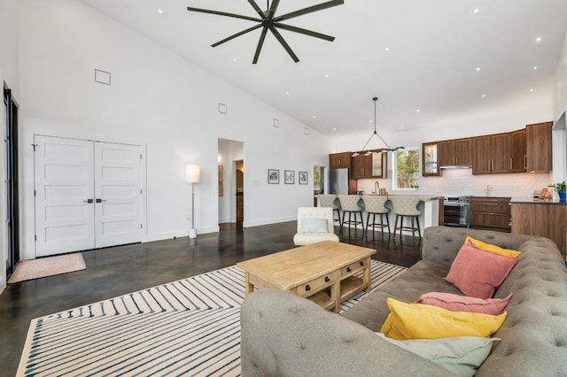 2300 Stagecoach Ranch Loop Unit B, Dripping Springs, TX 78620 - living room featuring finished concrete flooring, ceiling fan, high vaulted ceiling, baseboards, and recessed lighting