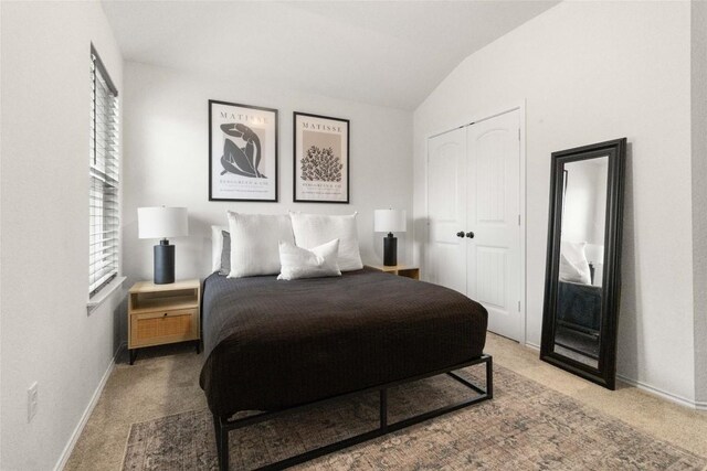 9003 Acorn Cup Dr Unit 34, Austin, TX 78748 - carpeted bedroom with vaulted ceiling, baseboards, and a closet