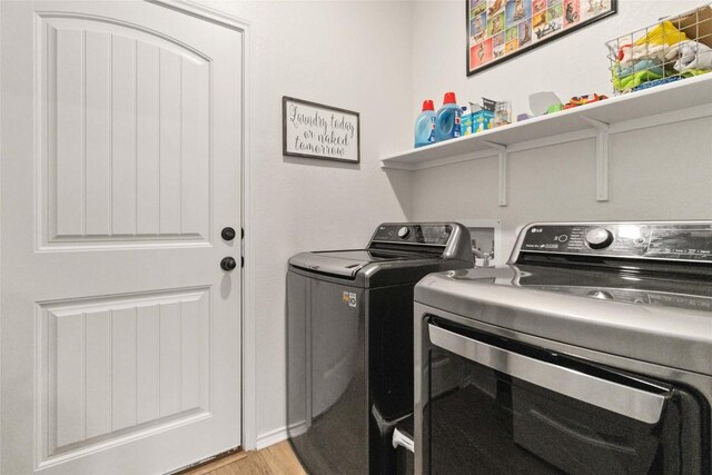 9003 Acorn Cup Dr Unit 34, Austin, TX 78748 - washroom featuring washer and clothes dryer and light wood-type flooring