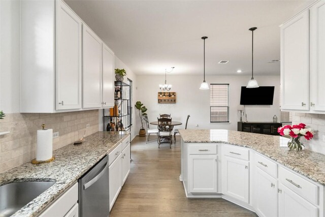 9003 Acorn Cup Dr Unit 34, Austin, TX 78748 - kitchen featuring stainless steel dishwasher, a peninsula, white cabinets, tasteful backsplash, and plenty of natural light