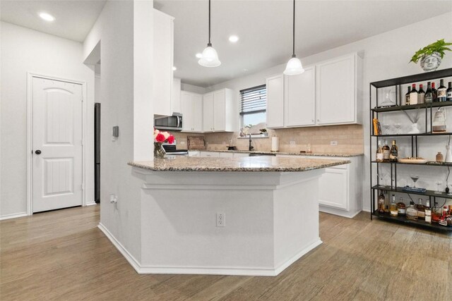 9003 Acorn Cup Dr Unit 34, Austin, TX 78748 - kitchen with appliances with stainless steel finishes, light wood finished floors, white cabinets, and recessed lighting