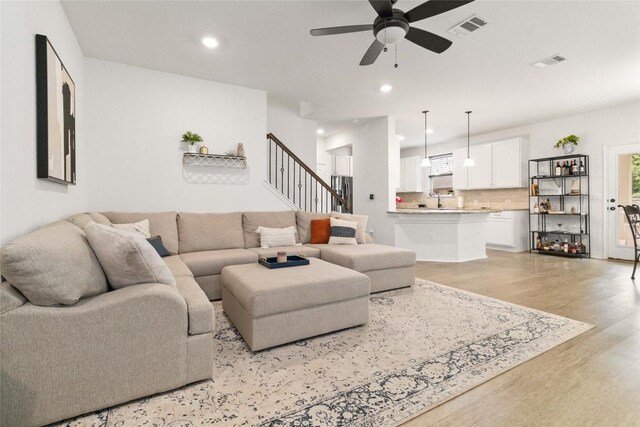 9003 Acorn Cup Dr Unit 34, Austin, TX 78748 - living area featuring light wood-style flooring, a ceiling fan, stairway, recessed lighting, and healthy amount of natural light
