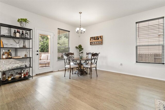 9003 Acorn Cup Dr Unit 34, Austin, TX 78748 - dining room with light wood-style floors, a chandelier, and baseboards