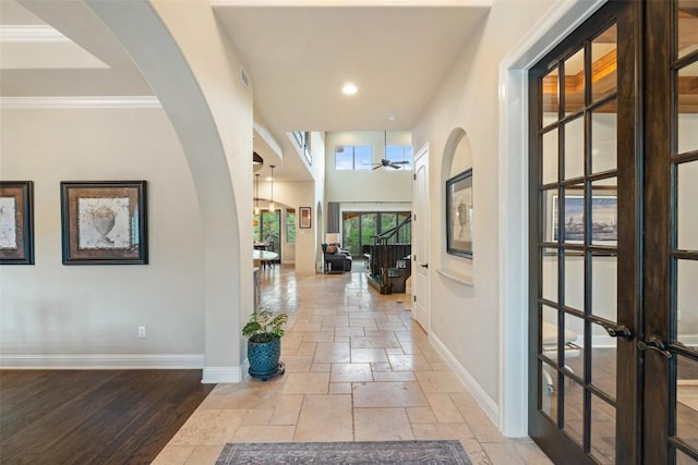 303 Bella Montagna Cir, Austin, TX 78734 - hall with stone tile floors, arched walkways, recessed lighting, and crown molding