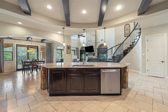 303 Bella Montagna Cir, Austin, TX 78734 - kitchen with ceiling fan, stone tile floors, beamed ceiling, arched walkways, and light stone counters