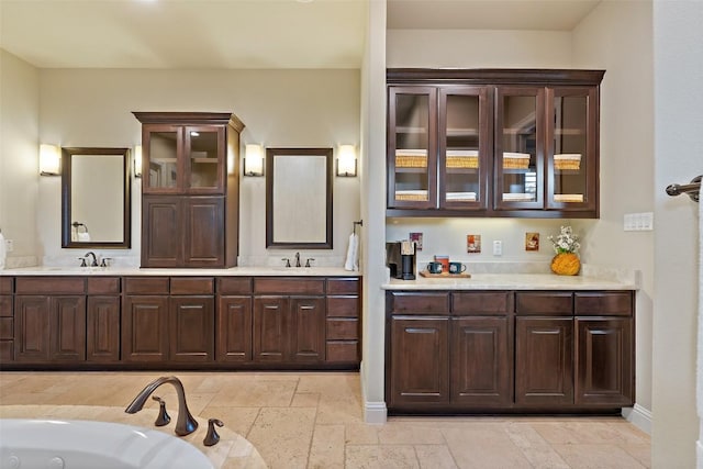 303 Bella Montagna Cir, Austin, TX 78734 - full bath featuring double vanity, stone tile floors, and a jetted tub