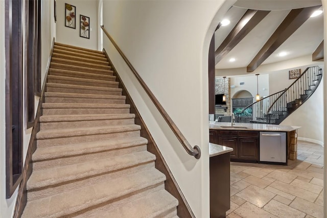 303 Bella Montagna Cir, Austin, TX 78734 - staircase with stone tile floors, beam ceiling, arched walkways, and recessed lighting