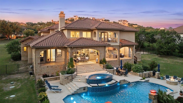 303 Bella Montagna Cir, Austin, TX 78734 - back of property with a balcony, a patio, a fenced backyard, and a tiled roof