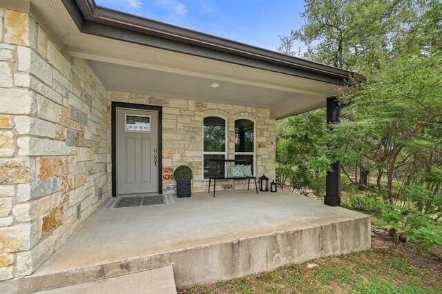 21003 Dodge Trl, Lago Vista, TX 78645 - entrance to property featuring stone siding and a porch