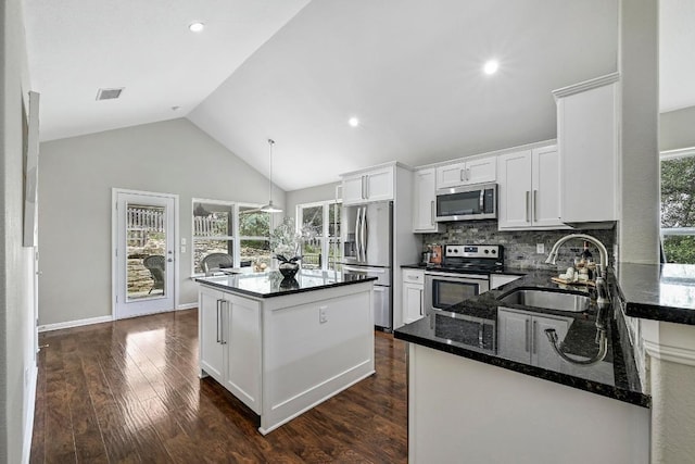 21003 Dodge Trl, Lago Vista, TX 78645 - kitchen with stainless steel appliances, dark wood-style flooring, a center island, white cabinetry, and backsplash