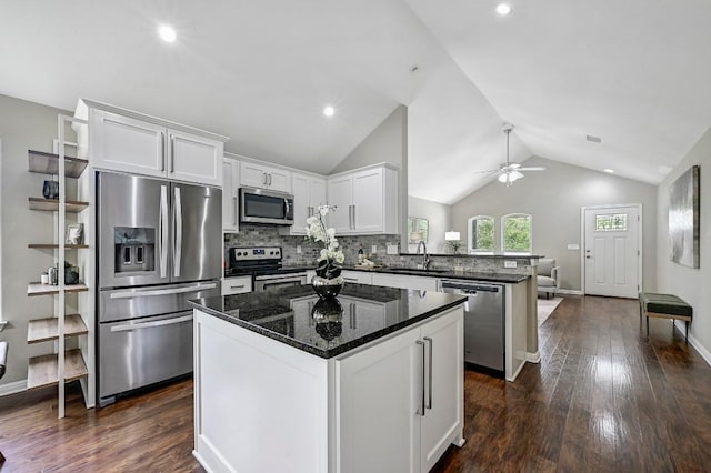 21003 Dodge Trl, Lago Vista, TX 78645 - kitchen with appliances with stainless steel finishes, a peninsula, vaulted ceiling, white cabinets, and ceiling fan