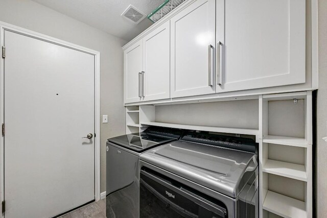 21003 Dodge Trl, Lago Vista, TX 78645 - laundry room with washing machine and clothes dryer and cabinet space
