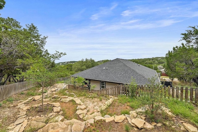 21003 Dodge Trl, Lago Vista, TX 78645 - view of property exterior with a fenced backyard and roof with shingles