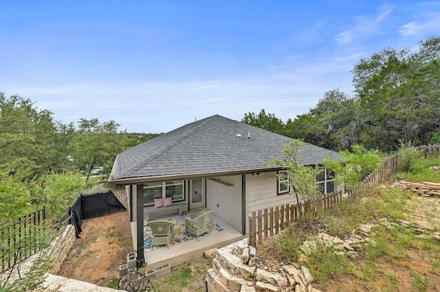 21003 Dodge Trl, Lago Vista, TX 78645 - back of house featuring a patio, roof with shingles, and a fenced backyard