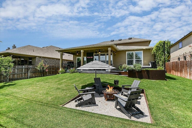 257 Culebra Dr, Georgetown, TX 78626 - back of property with an outdoor fire pit and a patio