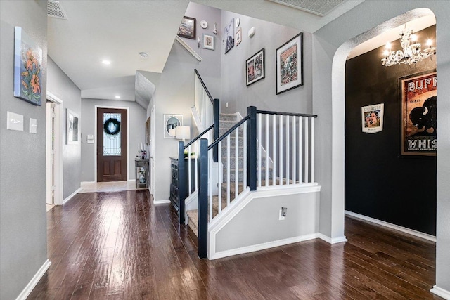 257 Culebra Dr, Georgetown, TX 78626 - foyer entrance with a chandelier, arched walkways, hardwood / wood-style flooring, and stairs