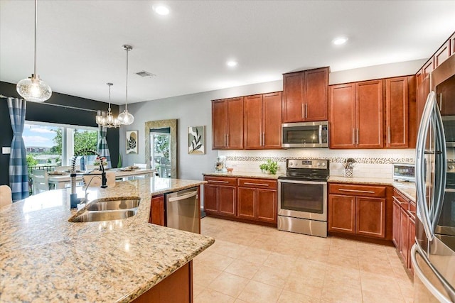 257 Culebra Dr, Georgetown, TX 78626 - kitchen with stainless steel appliances, a sink, backsplash, recessed lighting, and light stone counters