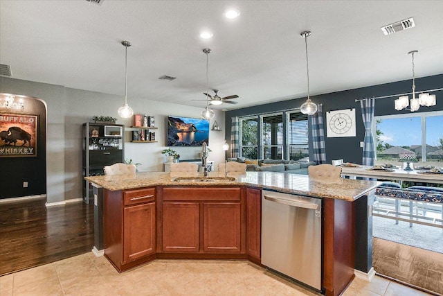 257 Culebra Dr, Georgetown, TX 78626 - kitchen featuring dishwasher, a sink, a chandelier, a ceiling fan, and brown cabinetry