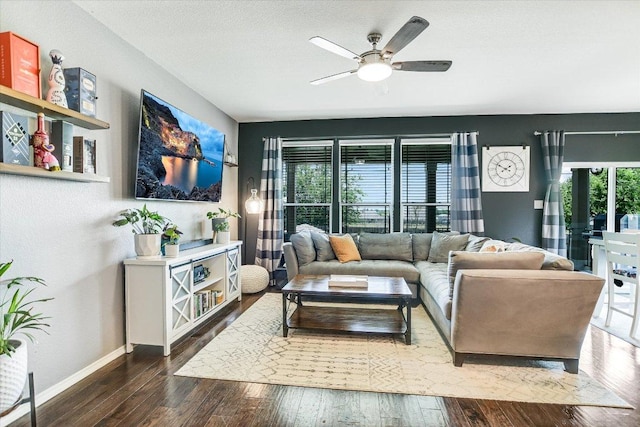 257 Culebra Dr, Georgetown, TX 78626 - living room featuring hardwood / wood-style floors, baseboards, a ceiling fan, and a textured ceiling