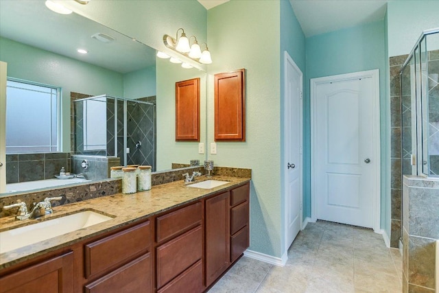 257 Culebra Dr, Georgetown, TX 78626 - bathroom featuring a shower stall, double vanity, tile patterned flooring, and baseboards
