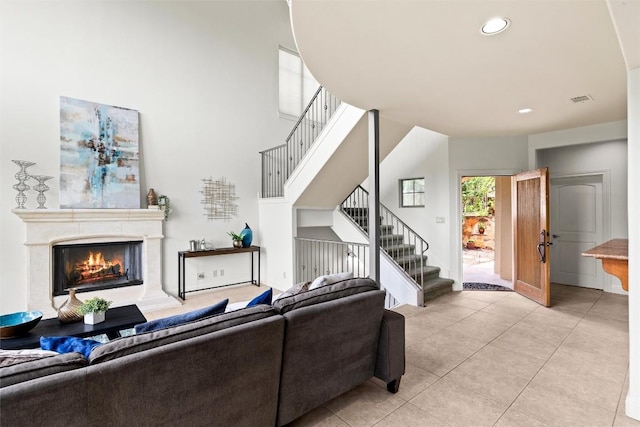 8546 Adirondack Trl Unit 14, Austin, TX 78759 - living area with light tile patterned flooring, stairs, a lit fireplace, and recessed lighting