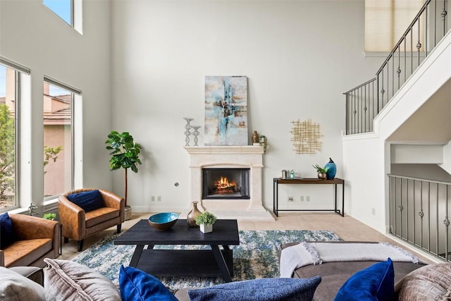 8546 Adirondack Trl Unit 14, Austin, TX 78759 - living area featuring a high ceiling, a lit fireplace, and stairway