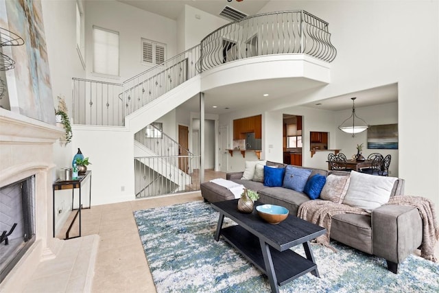 8546 Adirondack Trl Unit 14, Austin, TX 78759 - living room with a high ceiling, stairs, tile patterned floors, and a fireplace with raised hearth