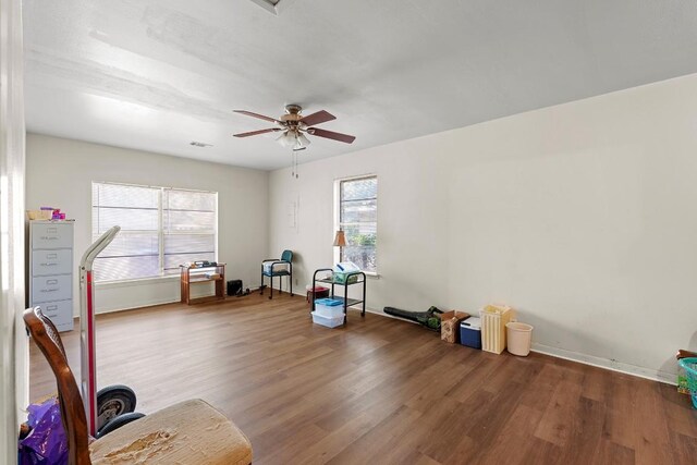 814 W Bell Ave, Rockdale, TX 76567 - exercise area featuring wood finished floors, a ceiling fan, and baseboards