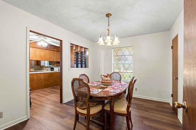 814 W Bell Ave, Rockdale, TX 76567 - dining area with a chandelier, dark wood finished floors, a textured ceiling, baseboards, and ceiling fan
