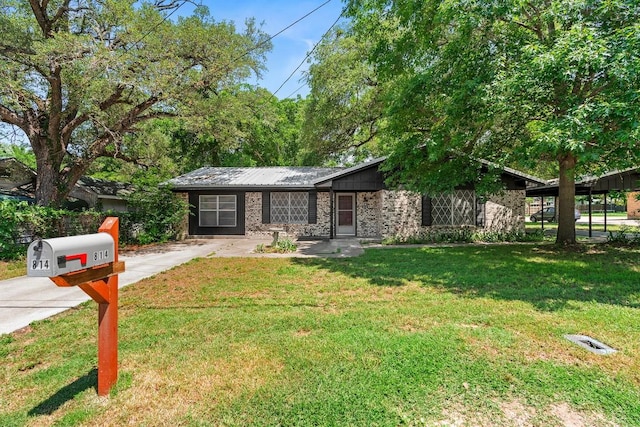 814 W Bell Ave, Rockdale, TX 76567 - view of front of home with a front yard, driveway, and metal roof