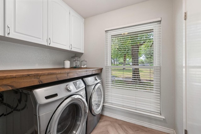 13201 Stillforest St, Austin, TX 78729 - laundry room featuring washer and dryer, cabinet space, and baseboards