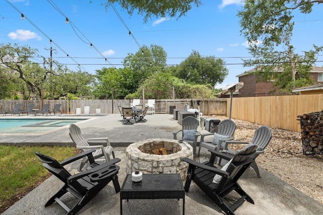 13201 Stillforest St, Austin, TX 78729 - fenced backyard featuring an outdoor fire pit, a patio area, and a pool with connected hot tub
