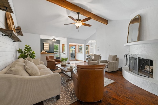 13201 Stillforest St, Austin, TX 78729 - living room with dark wood-type flooring, a fireplace with raised hearth, ceiling fan, and arched walkways