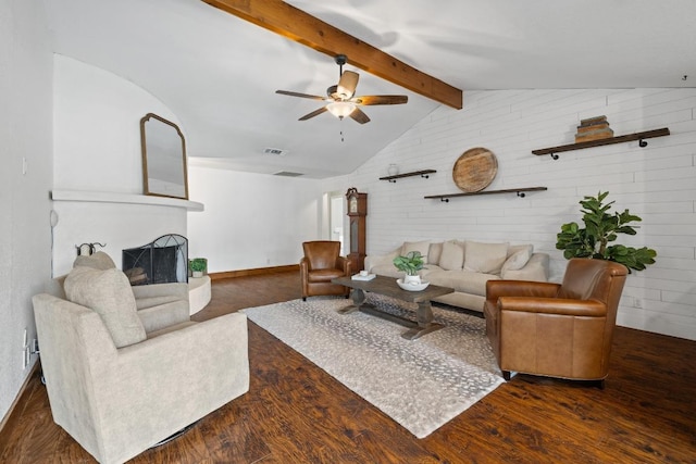13201 Stillforest St, Austin, TX 78729 - living area featuring wood finished floors, a ceiling fan, a fireplace with raised hearth, and baseboards