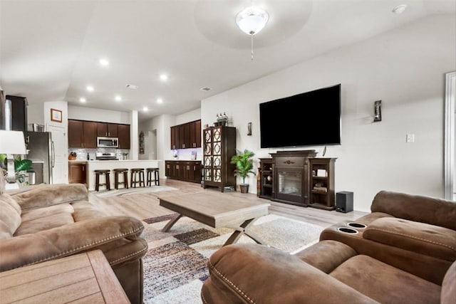 320 Bright Star Ln, Georgetown, TX 78628 - living room with lofted ceiling, light wood finished floors, recessed lighting, a ceiling fan, and a fireplace