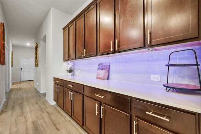 320 Bright Star Ln, Georgetown, TX 78628 - kitchen featuring backsplash, light wood-style flooring, light countertops, and baseboards