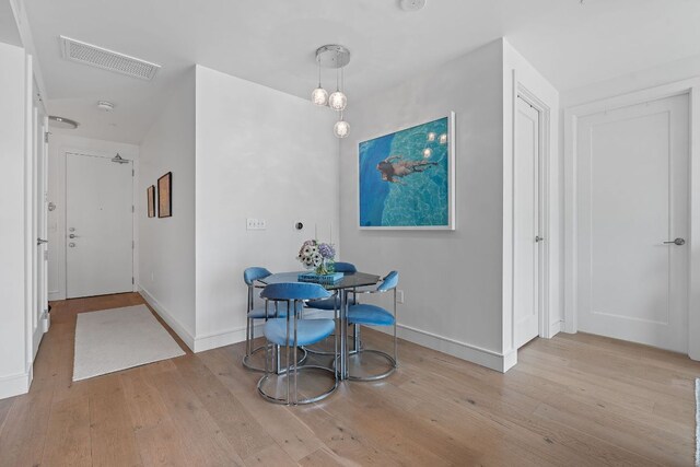 222 W Ave Unit 1001, Austin, TX 78701 - unfurnished dining area featuring wood finished floors and baseboards