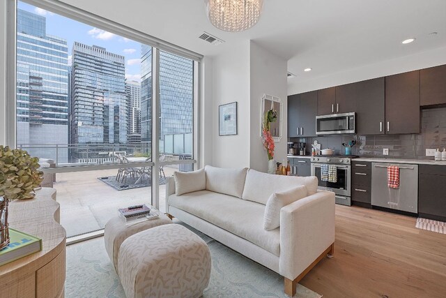 222 W Ave Unit 1001, Austin, TX 78701 - living area featuring expansive windows, light wood-type flooring, a chandelier, recessed lighting, and a city view