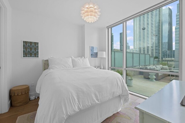 222 W Ave Unit 1001, Austin, TX 78701 - bedroom with wood finished floors, a city view, and a wall of windows