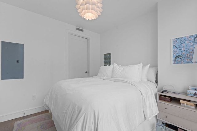 222 W Ave Unit 1001, Austin, TX 78701 - bedroom featuring electric panel, wood finished floors, and baseboards
