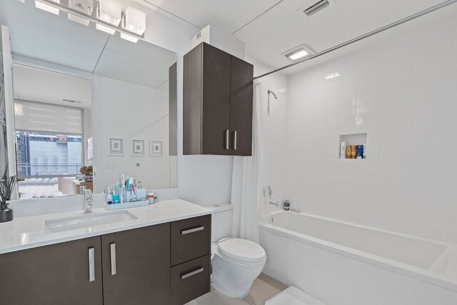 222 W Ave Unit 1001, Austin, TX 78701 - bathroom featuring vanity, toilet, shower / bath combo with shower curtain, and tile patterned floors
