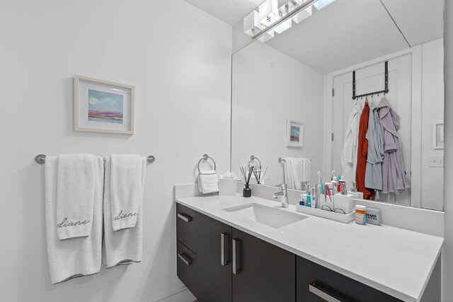 222 W Ave Unit 1001, Austin, TX 78701 - bathroom featuring vanity and baseboards