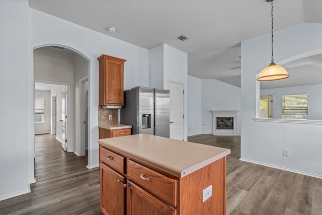 2141 Rachel Ln, Round Rock, TX 78664 - kitchen with stainless steel fridge with ice dispenser, arched walkways, dark wood-style floors, light countertops, and lofted ceiling