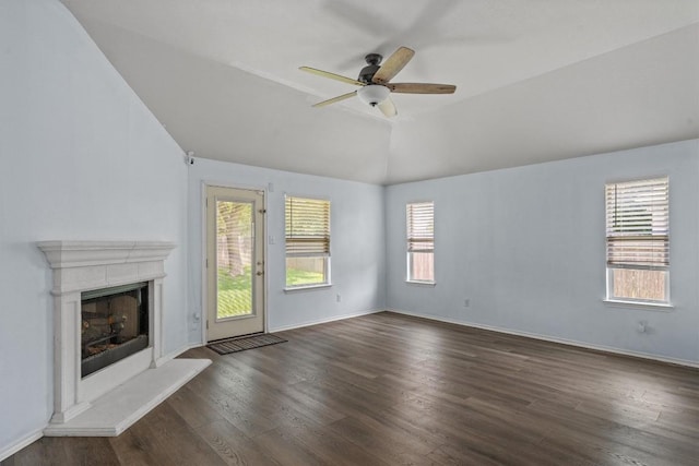 2141 Rachel Ln, Round Rock, TX 78664 - unfurnished living room featuring plenty of natural light, dark wood-style flooring, a fireplace with raised hearth, and lofted ceiling