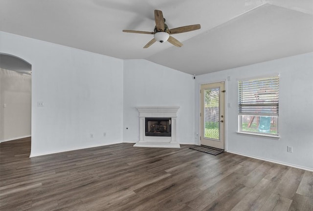 2141 Rachel Ln, Round Rock, TX 78664 - unfurnished living room featuring lofted ceiling, wood finished floors, a fireplace with raised hearth, a ceiling fan, and baseboards