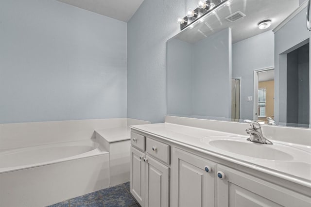2141 Rachel Ln, Round Rock, TX 78664 - bathroom with vanity, a bath, and tile patterned floors